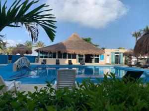 a resort with a swimming pool with chairs and a building at Penthouse 1AB on the beach with sea views in Cancún