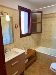 a bathroom with a sink and a tub and a toilet at Casa Mojapies in Ribadesella