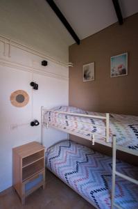 a bedroom with two bunk beds and a night stand at Heuvel 35 in Simpelveld