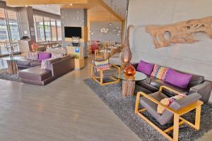 a lobby with couches and chairs and a table at GHL Style Yopal in Yopal +45 photos
