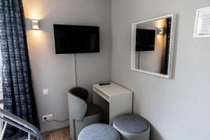 Una televisión o centro de entretenimiento en Hotel Bristol