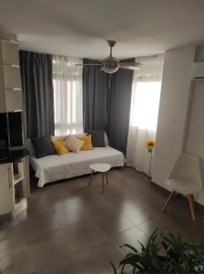 a bedroom with a bed with yellow pillows on it at Apartamento CANDELA in Fuengirola