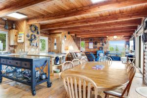 a kitchen and dining room with a wooden table and chairs at Port Angeles Blue Mountain Lodge with Bunkhouse in King Hill