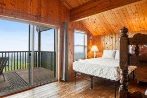 a bedroom with a bed and a balcony at Port Angeles Blue Mountain Lodge with Bunkhouse in King Hill