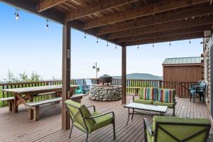 a deck with chairs and a table and a grill at Port Angeles Blue Mountain Lodge with Bunkhouse in King Hill