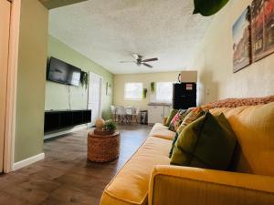 a living room with a couch and a flat screen tv at Apartment near TPA Airport in Tampa
