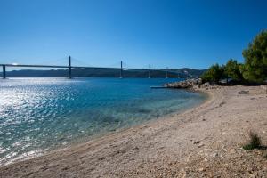 a beach with a bridge in the background at Villa Mare in Klek