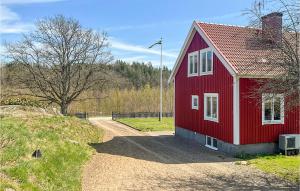 a red house sitting on top of a dirt road at Awesome Home In Tving With Wifi And 3 Bedrooms in Tving