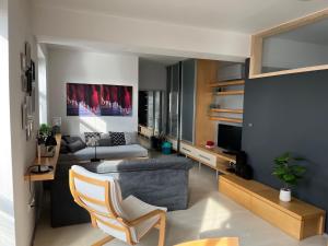 a living room with a couch and a tv at Apartmán Dolné Bašty in Trnava