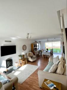 a living room with a couch and a tv at Rockview Beadnell - Perfect Family Retreat in Beadnell