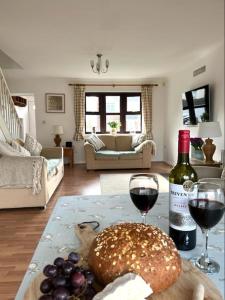 a living room with a table with two glasses of wine at Rockview Beadnell - Perfect Family Retreat in Beadnell