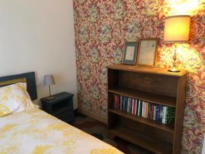 a bedroom with a bed and a book shelf with books at Casa Vacanze Labiena 129 in Laveno