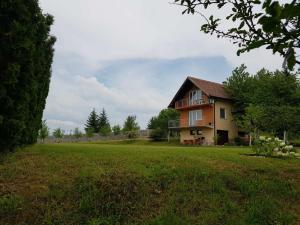 a house in a field with a large yard at Vila Haris in Sarajevo