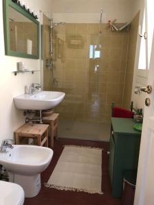 a bathroom with a sink and a toilet and a shower at Casa Vacanze Labiena 129 in Laveno +18 photos