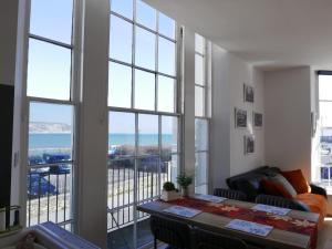 a living room with a view of the ocean at SeaViewApartment in Swanage