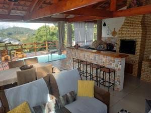 a living room with a table and chairs and a fireplace at Cantin da Mata in Domingos Martins