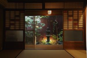 una entrada a un edificio con jardín a través de una ventana en Guesthouse Yululu, en Kioto