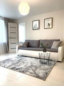 a living room with a couch and a table at New Modern Apartments in the City Center in Narva