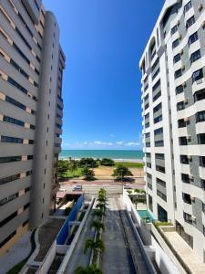 a view of the beach from between two buildings at VISTA MAR BOA VIAGEM - BEACH CLASS EXECUTIVE in Recife