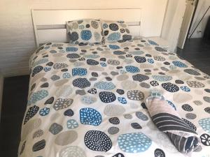 a bed with a blue and white comforter and pillows at Nice Entire Semi - Attached House - M in Umeå