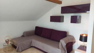 a living room with a couch in a room at Apartments Nikola Caska in Novalja