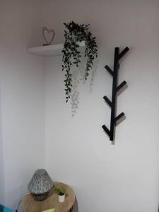 a table with a shelf and a cross on a wall at Το Κεντρικό διαμέρισμα της πόλης in Larisa