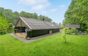 a large green building in a field of grass at Amazing Home In Haderslev With Wifi in Haderslev