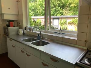 a kitchen counter with a sink and a window at Loveland in Bergen