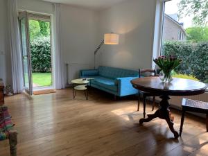a living room with a blue couch and a table at Loveland in Bergen +11 photos