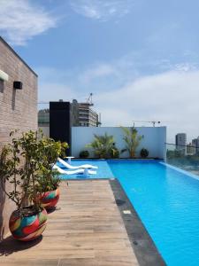 a swimming pool on the roof of a building at El Sol by Wynwood House in Lima