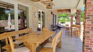 ein Esszimmer mit einem Holztisch und Stühlen in der Unterkunft Villa Alara - charming villa with heated swimming pool in Milohnići