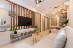 a living room with a couch and a tv at The Sóng Apartment - Nhà Của Kim in Vung Tau