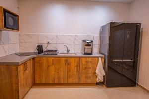 a kitchen with a sink and a refrigerator at וילה לין בחרמון in Majdal Shams