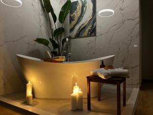 a bathroom with a tub with two candles and a table at Casa Benita in Hvar