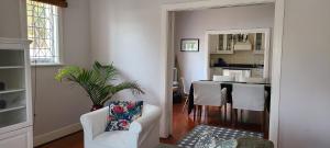 a living room with a white couch and a kitchen at Innes Road Durban Accommodation Private Double Room with Private Bathroom in Durban