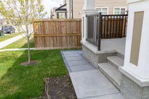 a walkway leading to a yard with a fence at The Jade Place in Airdrie