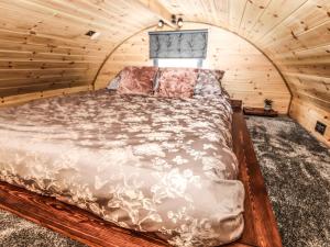 a bedroom with a bed in a wooden room at Offas Dyke Escape in St Asaph