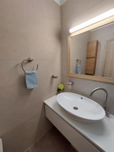 a bathroom with a white sink and a mirror at Brna Three-room apartment near the beach-Zen in Brna