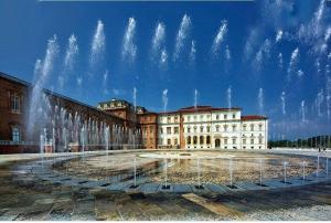 un grand bâtiment avec une fontaine devant lui dans l'établissement MELIREB APPARTAMENT ELEGANCE, à Turin