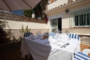 a table with a white table cloth and blue chairs at gcprestige in Estepona