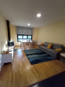 a living room with a couch and a table at Lillo Home in Puebla de Lillo