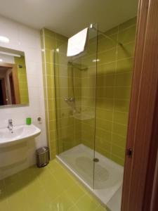 a bathroom with a shower and a sink at Lillo Home in Puebla de Lillo