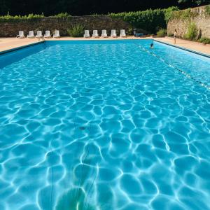 uma grande piscina com água azul em Chambre d’hôtes calme - Canal Nantes à Brest em Plessé