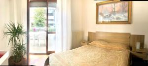 a bedroom with a bed and a sliding glass door at Appartamento del sole in San Benedetto del Tronto