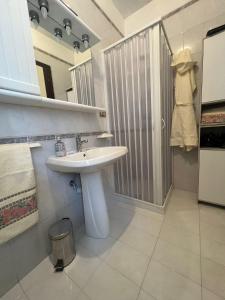 a bathroom with a white sink and a shower at Appartamento del sole in San Benedetto del Tronto
