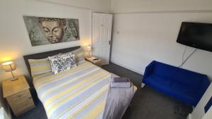 a bedroom with a bed and a flat screen tv at Alexandra Park House in Belfast