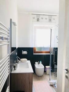 a bathroom with a white sink and a toilet at Blumarine in Palau