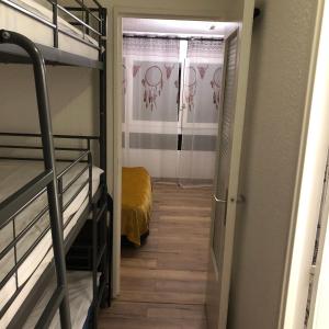 a hallway leading to a room with bunk beds at Studio Puy saint vincent 1600 in Les Prés