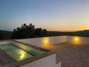 a swimming pool on the roof of a house at Eco-Villa Monte Do Barrocalinho in Loulé