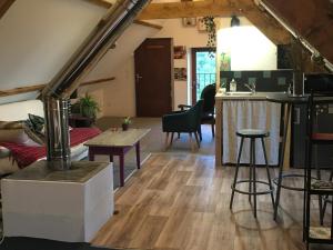 an attic living room with a kitchen and a living room at Chez Fred avec vue sur le Château in Angles-sur-lʼAnglin